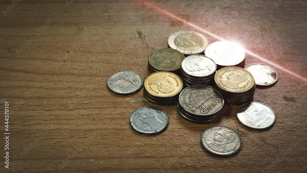 Double exposure of light and stack of coins for finance and banking concept, coins stacked background, copy space for texting. Double exposure of light and stack of coins for finance and banking concept, coins stacked background, copy space for texting.