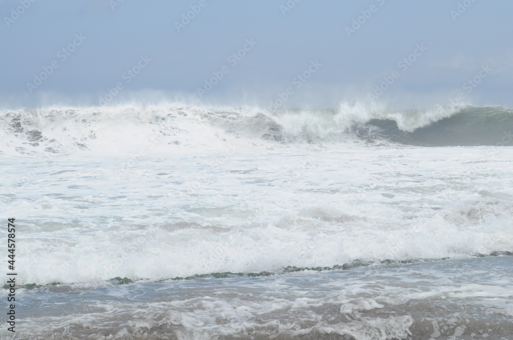 View of sandy beach in Malang district and waves in the sea on a sunny day. View of sandy beach in Malang district and waves in the sea on a sunny day.