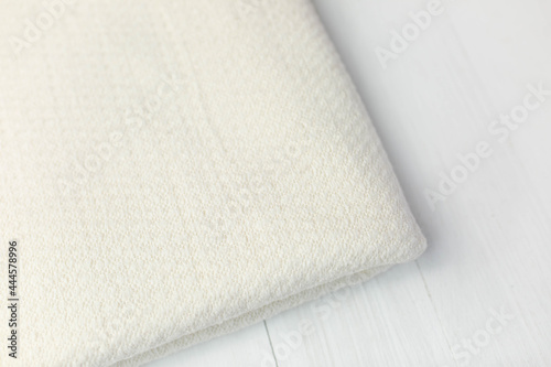 The fabric is milky-colored jersey. Cut for clothes on a white background