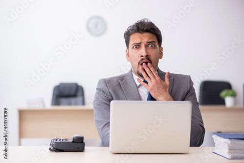 Young male employee working in the office