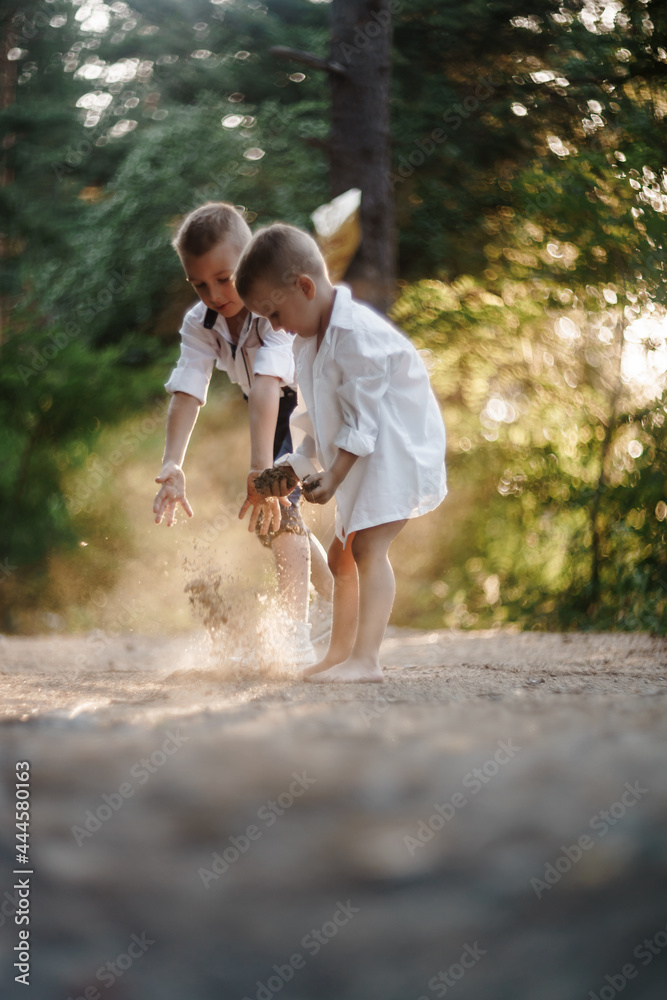 Obraz premium two little boys are playing outside