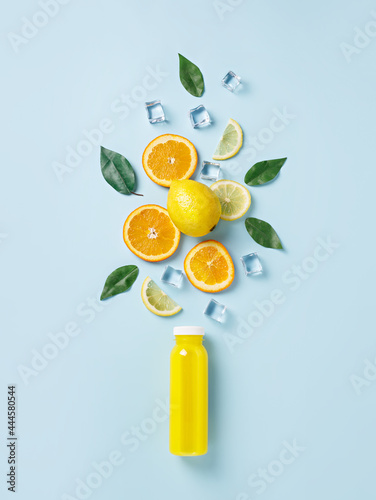 Fototapeta Naklejka Na Ścianę i Meble -  Summer tropical fruits and ice cubes as ingredients for healthy multivitamin juice. Cold refreshing drink made of lemon, lime, orange, ice, and grapefruits. Creative summer drink concept. Flat lay.