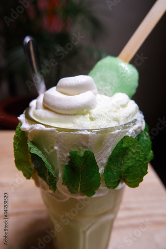 Greentea milkshake topping ice cream on a table photo