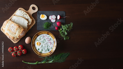 Traditional okroshka soup on kefir with egg and dill.  ingredients for okroshka on the table