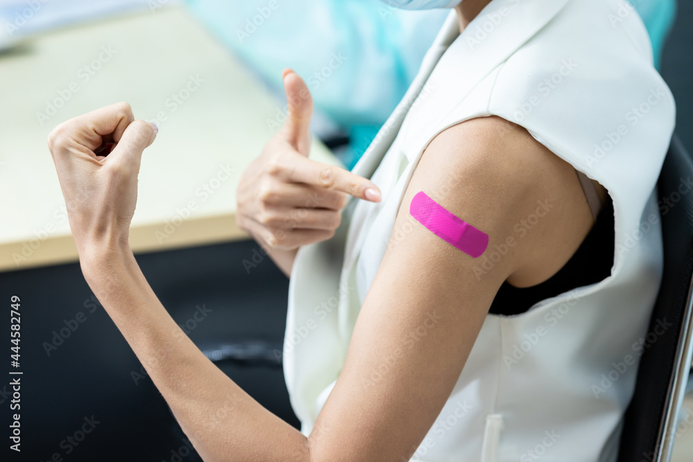 woman wearing mask getting vaccinated concept of coronavirus vaccination mask grown woman approved for covid-19 vaccination at the hospital. Female doctor immunizes against the virus,  medical plaster