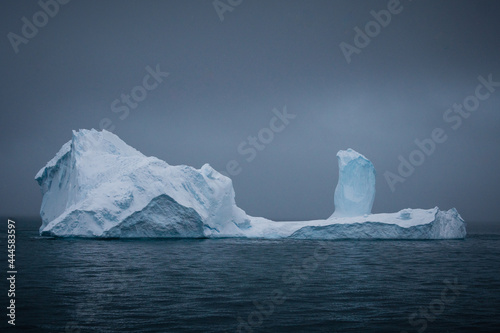 Large iceberg with a dark sky in the Gerlache strait, Antarctica.