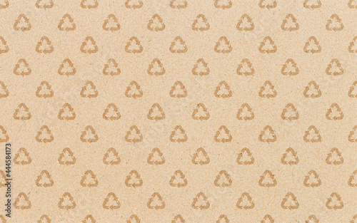 Recycle symbol pattern on brown paper background