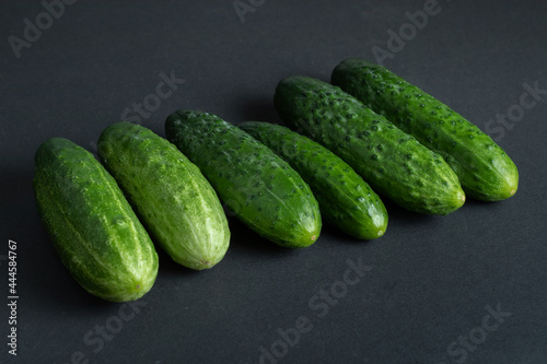 Fresh cucumbers on dark background