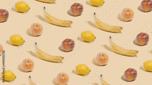 A creative idea of pattern made of .fruits in plastic wrap. Minimal fruit concept.