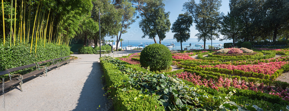 spa garden Opatija, Croatia with bamboo, buxus and begonia flower beds at the seaside