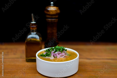 Encebollado, a dish from the coast of the equator, oil and pepper in the background for concept food  photo