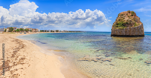 Fototapeta Naklejka Na Ścianę i Meble -  Salento coast: Torre Pali in Apulia, Italia.The ruined sixteenth century watchtower of Torre Pali, surrounded by crystal clear water, appears in the blue water, a few metres away from the coast.