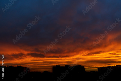 stunning sunset of intense blue and orange colours on a hot summer day in the city of Zaragoza, Spain.