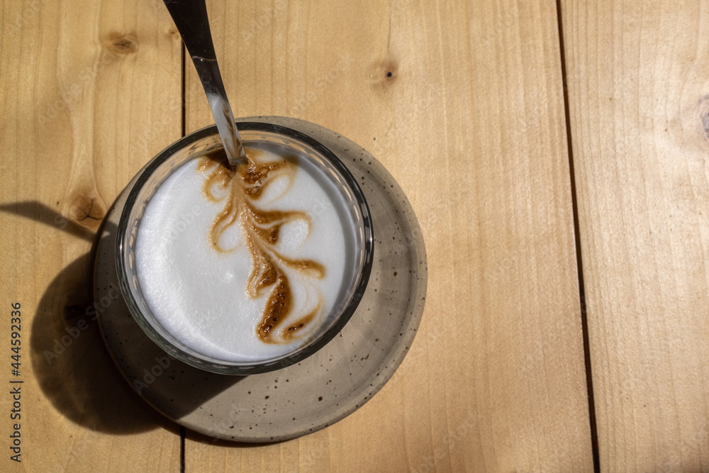 Fototapeta premium Latte macchiato with latte art on a wooden table