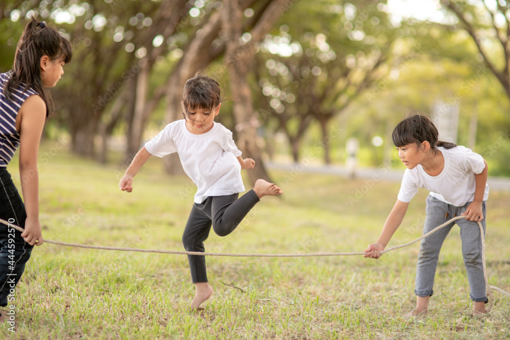 Happy kids playing together with jumping rope outdoors Stock Photo ...