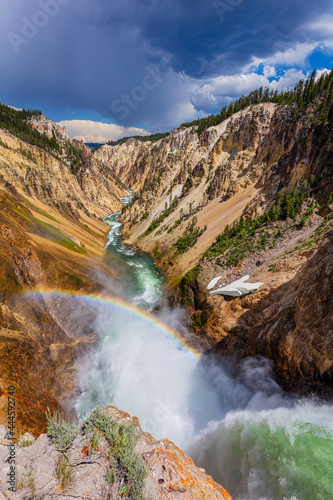 Rainbow over the waterfall. Amazing mountain landscape. Big waterfall among the beautiful rocks. Brink of the Lower Falls on the Grand Canyon of the Yellowstone, Yellowstone National Park, USA