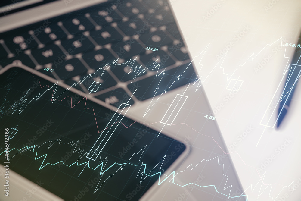 Multi exposure of abstract financial graph on laptop background, financial and trading concept Multi exposure of abstract financial graph on laptop background, financial and trading concept