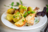 baked chicken leg with early potatoes and zucchini