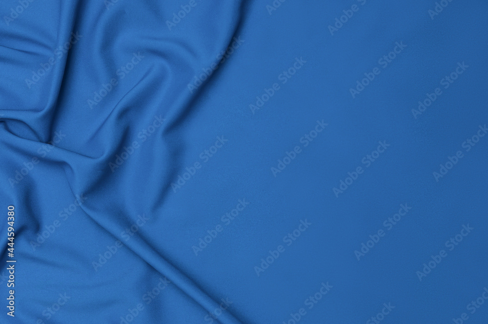 Smooth elegant blue tissue abstract background. Textile background. Cloth wallpaper. Graphics design element
