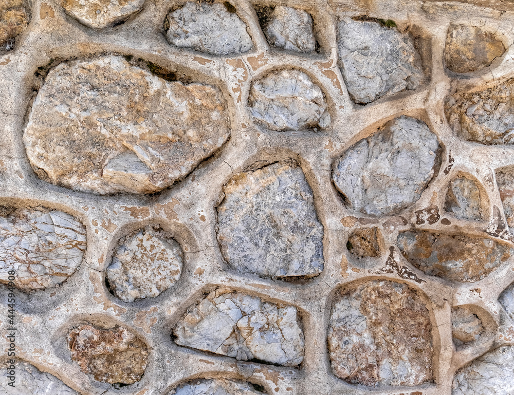 rough stone wall closeup, seamless natural background rough stone wall closeup, seamless natural background