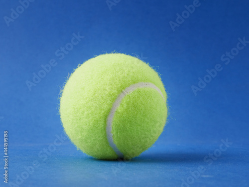 Tennis ball isolated on a blue background © Mikhail
