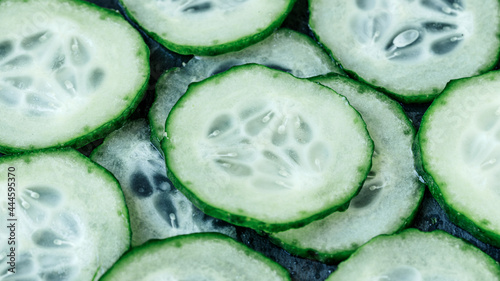 Pieces of green cucumber circles macro photo, vegetables for a healthy diet photo