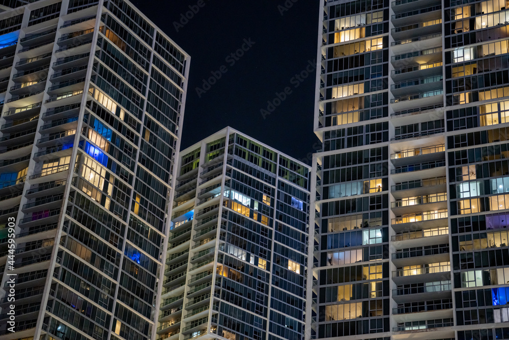 Highrise condos in the city lit at night Highrise condos in the city lit at night
