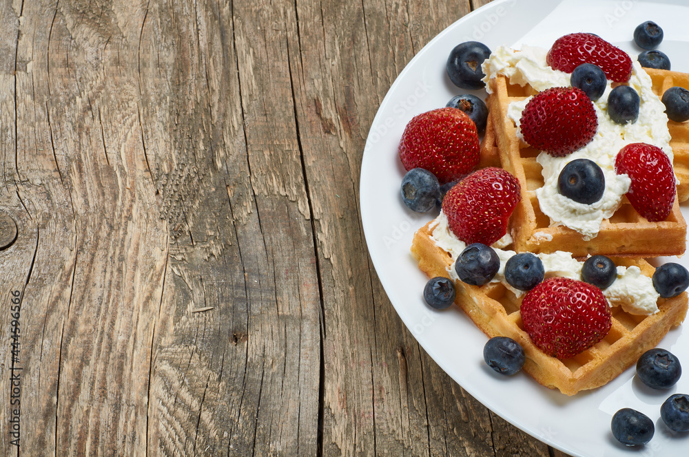 waffles with whipped cream and strawberries and blueberries waffles with whipped cream and strawberries and blueberries