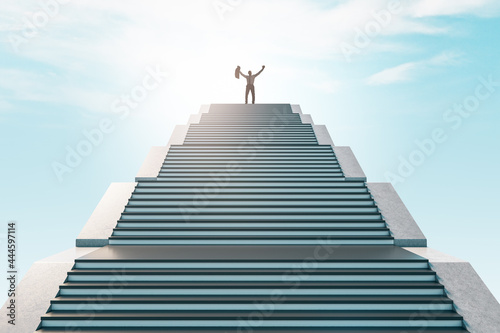 Happy businessman standing on top of staircase on bright sky background. Success and achievement concept.