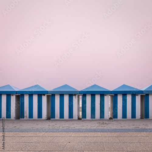 Row of vintage wooden beach huts on the beach of Dunkirk in France
