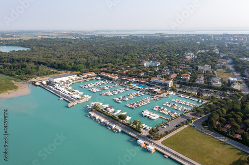 Lignano Riviera Marina at the Tagliamento river in Udine region, Italy. Small little port harbor for motorboats close to Sabbiadoro in the adriatic sea.