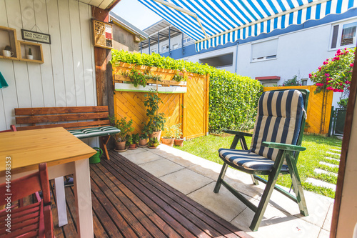 Billede på lærred Cozy and homely veranda with little garden, summer time