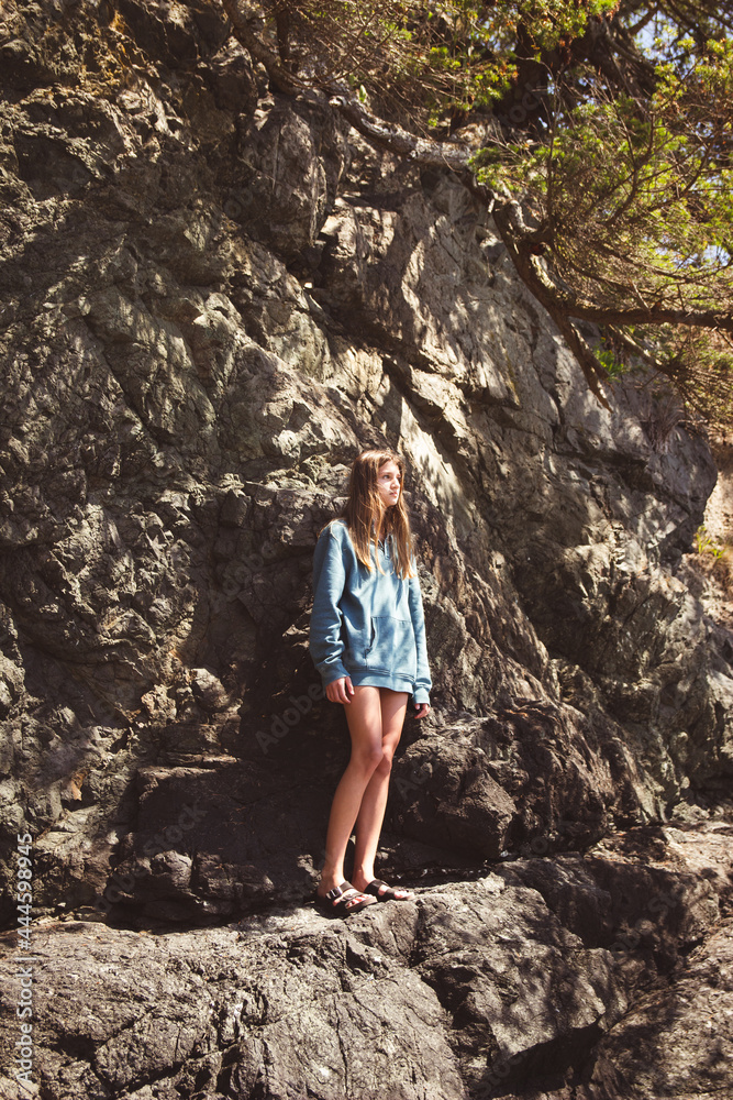 girl standing on rock ledge 