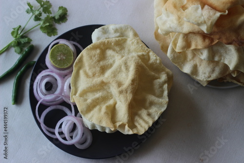 A papadum also called papad is a thin, crisp, round flatbread from India photo