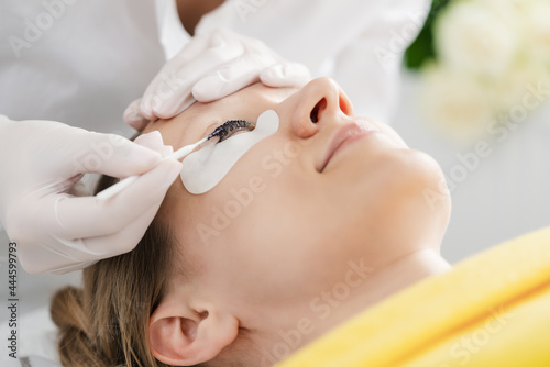 Lashes treated professionally in beauty salon © Kzenon