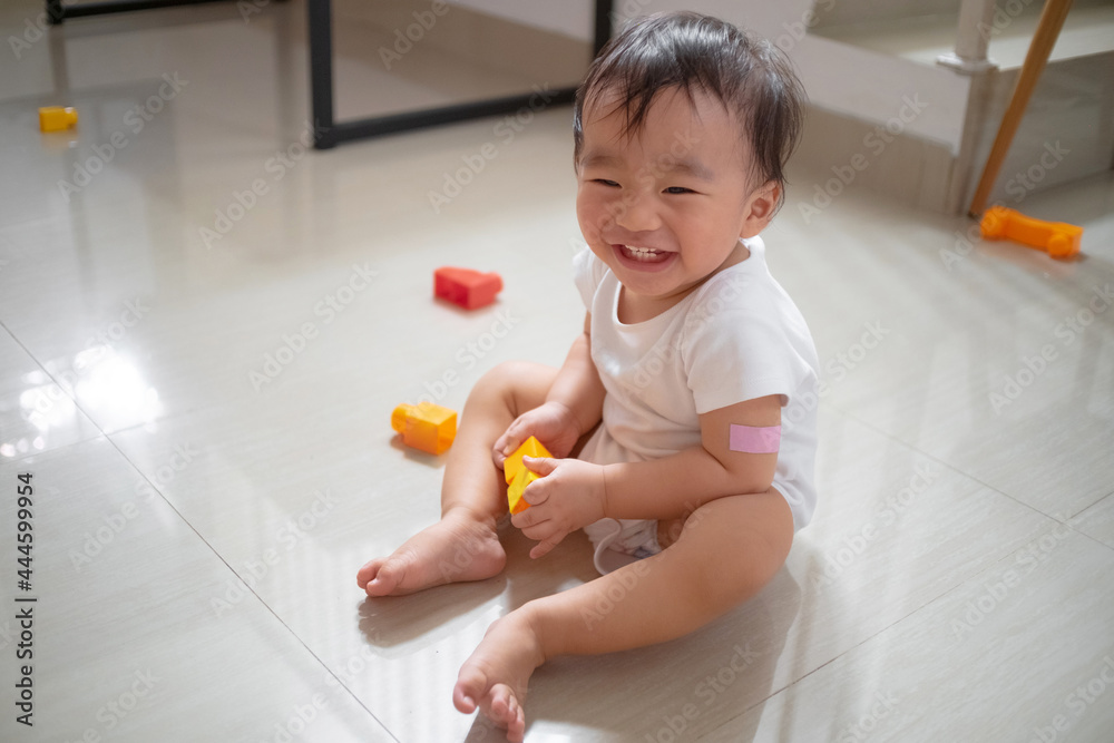 Toddler playing toys on the floor Toddler playing toys on the floor