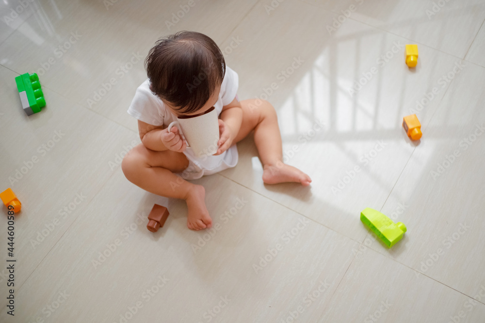 Toddler playing toys on the floor Toddler playing toys on the floor