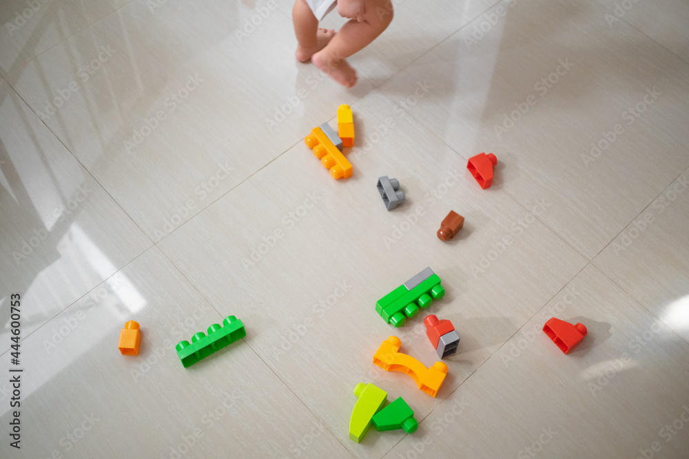 Toddler playing toys on the floor Toddler playing toys on the floor