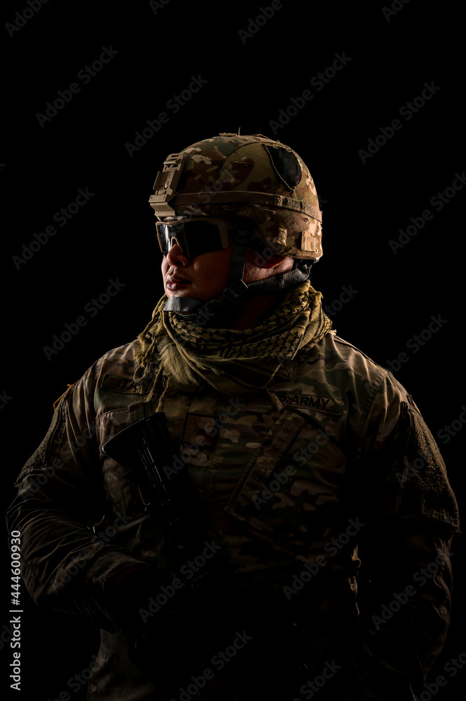 Photo of soldier in black background. Special forces United States soldier or private military contractors holding rifle. Image on black background. soldier, army, war, weapon and technology concept.