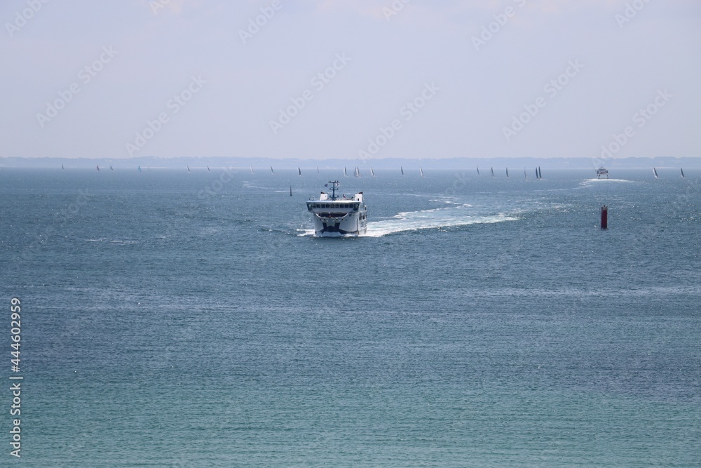 Ferry boat and sailboats in the sea Ferry boat and sailboats in the sea