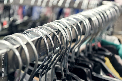 Metall hangers with clothes in the store