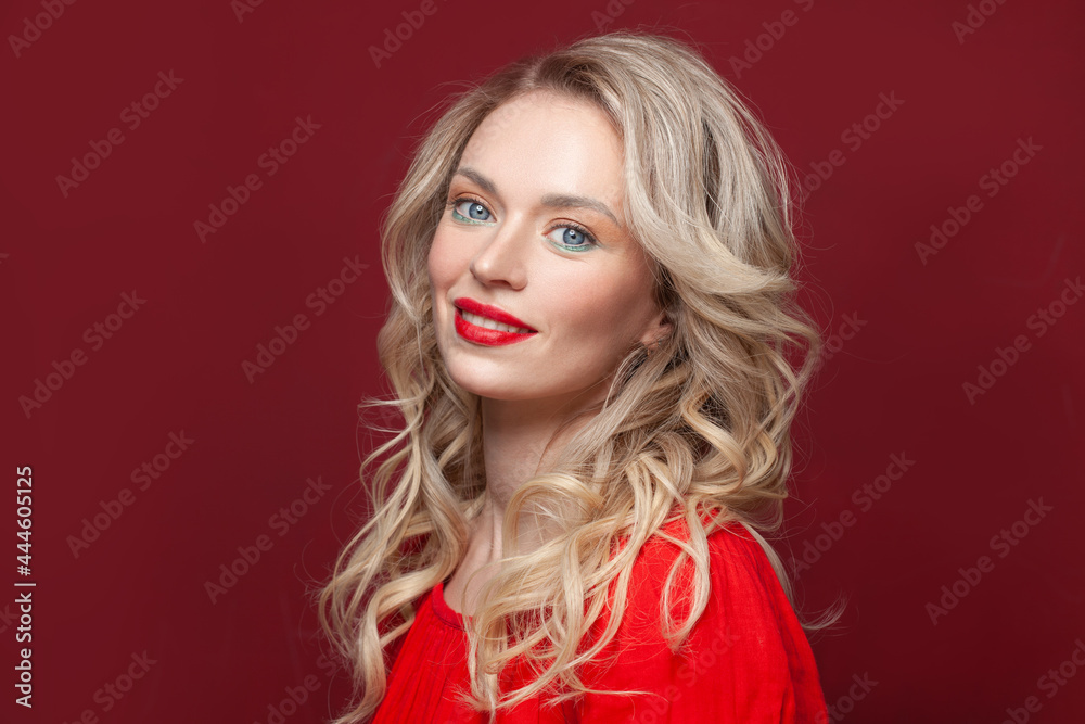 Happy fashion model woman smiling, beautiful female face close up on red background Happy fashion model woman smiling, beautiful female face close up on red background