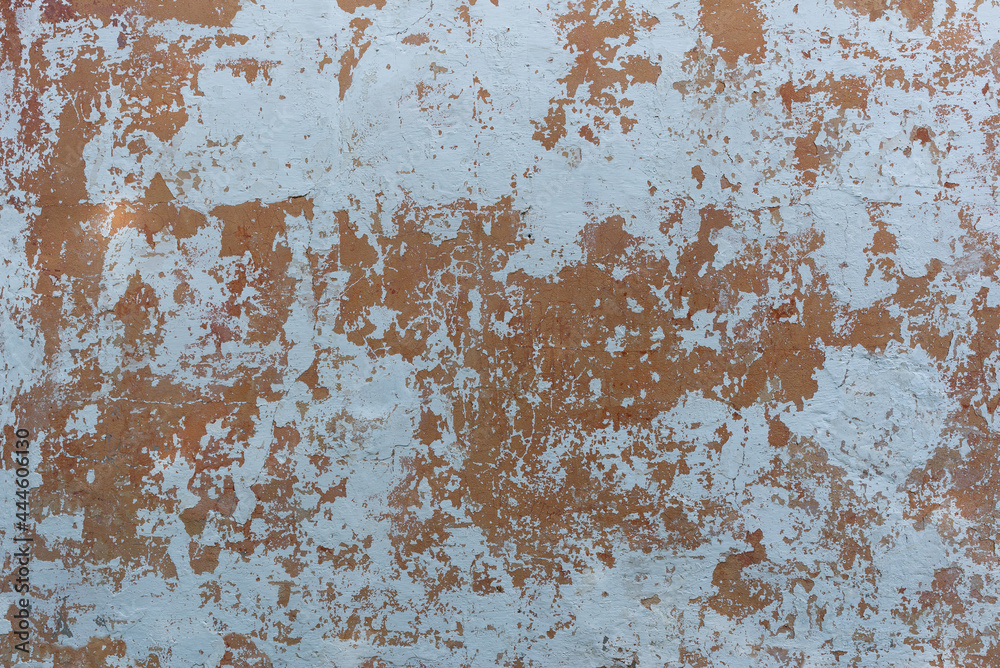 Painted old wall with a peeling lime layer Painted old wall with a peeling lime layer