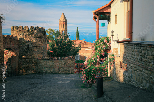 View of Sighnaghi in winery region of Georgia, Kakheti, during sunset in summer with Caucasus mountains in the background photo