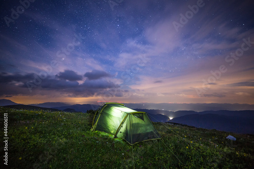 camping in the mountains with a tent at night