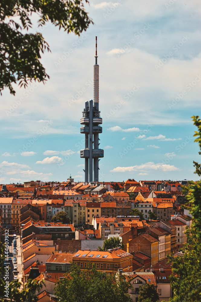 Obraz premium czech tv tower under bright blue sky with brown roof of old houses