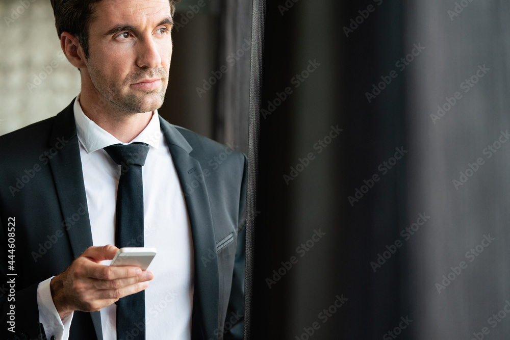 Young businessman sending message with mobile phone Young businessman sending message with mobile phone