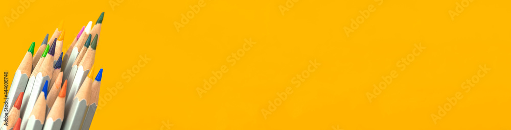 Wide banner with color pencils close-up. Yellow background with copy space Wide banner with color pencils close-up. Yellow background with copy space