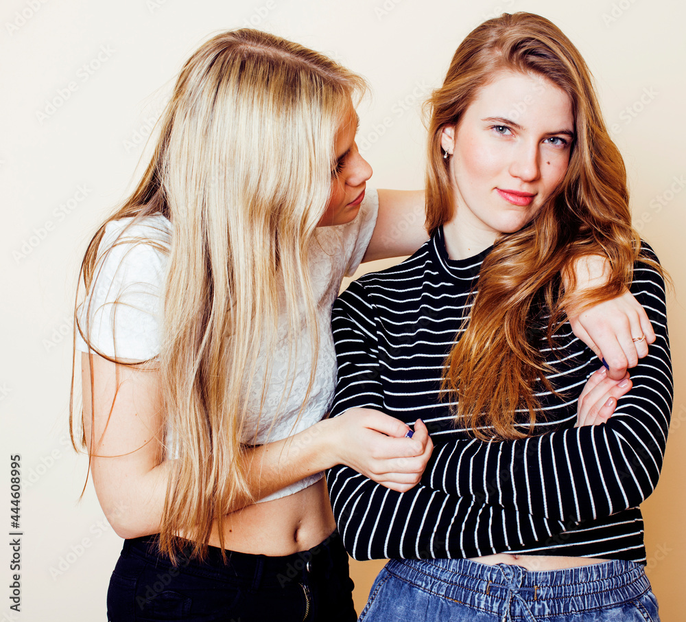 lifestyle and people concept: Fashion portrait of two stylish sexy girls best friends, over white background. Happy time for fun. One with hard feelings lifestyle and people concept: Fashion portrait of two stylish sexy girls best friends, over white background. Happy time for fun. One with hard feelings