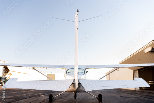 Rear tail view of a small private airplane on the tarmac photo